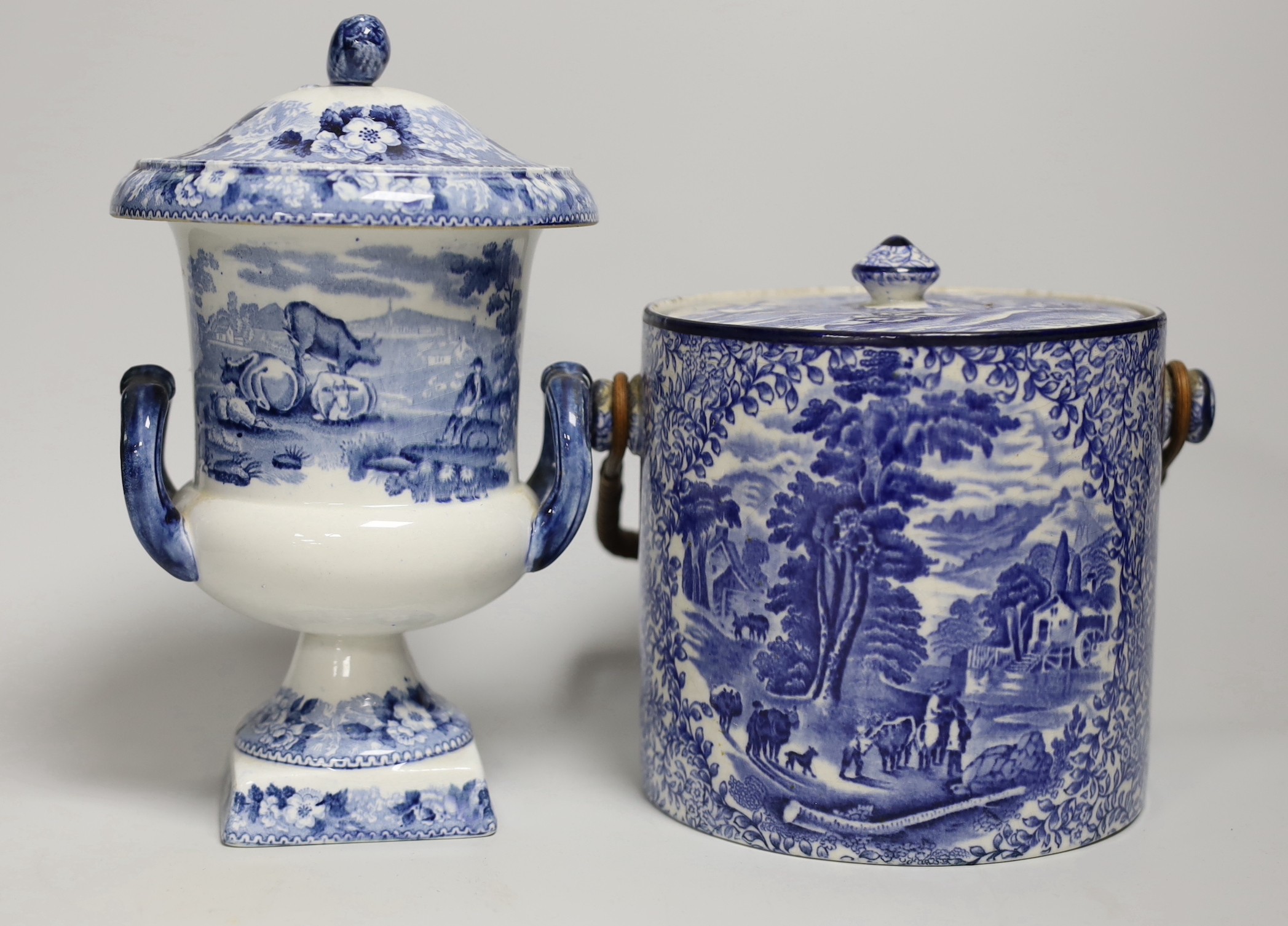 Blue and white pottery- A Victorian Willow pattern comport, a biscuit barrel and an urn with cover